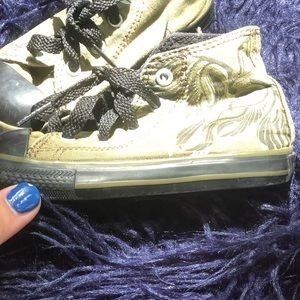 Olive green high top converse all stars.